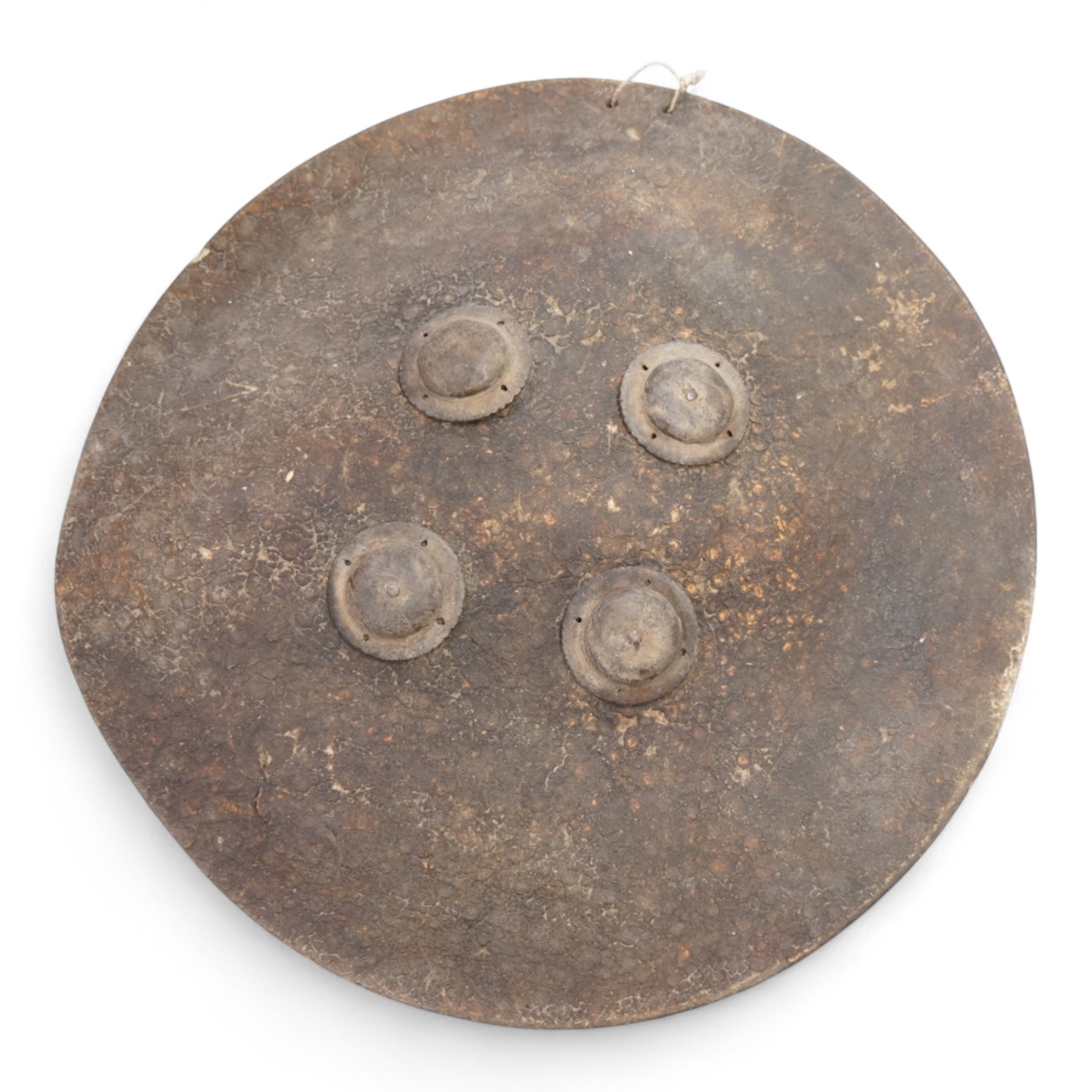 An Indian hide shield or dhal with four roundels, 47cm in diameter